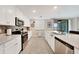 Well-lit kitchen showcasing stainless steel appliances and white cabinetry at 12425 Ghiberti Cir # 101, Venice, FL 34293