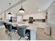 Spacious kitchen island featuring white cabinets and bar stool seating at 12425 Ghiberti Cir # 101, Venice, FL 34293