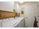 Well-organized laundry room with washer, dryer, white cabinets, and a functional layout, simplifying chores at 12425 Ghiberti Cir # 101, Venice, FL 34293