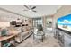 A comfortable living room area features a plush sofa, modern decor, and an open layout with the kitchen and dining areas at 12425 Ghiberti Cir # 101, Venice, FL 34293