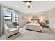 Bedroom with a ceiling fan, neutral color palette, and a serene lake view at 12425 Ghiberti Cir # 101, Venice, FL 34293