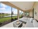 Screened-in patio with comfortable seating and scenic lake views at 12425 Ghiberti Cir # 101, Venice, FL 34293