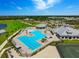 Aerial view of the resort-style pool, clubhouse, and surrounding community at Heritage Landing at 14684 Cherry Blossom Way, Punta Gorda, FL 33955