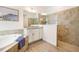 Bathroom with tile shower and floors, white vanity with granite countertops at 14684 Cherry Blossom Way, Punta Gorda, FL 33955