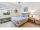 Bedroom with neutral decor, wood-look tile floors, and window at 14684 Cherry Blossom Way, Punta Gorda, FL 33955