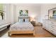 Bedroom with neutral decor, wood-look tile floors, and a window view at 14684 Cherry Blossom Way, Punta Gorda, FL 33955