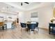 Bright dining area showcasing wood-look tile flooring and modern decor at 14684 Cherry Blossom Way, Punta Gorda, FL 33955