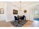 Chic dining room with a decorative chandelier, stylish rug, and elegant table setting at 14684 Cherry Blossom Way, Punta Gorda, FL 33955
