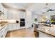 Modern kitchen featuring granite countertops, stainless steel appliances, and ample cabinet space at 14684 Cherry Blossom Way, Punta Gorda, FL 33955