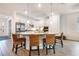 Well-lit kitchen with granite countertops, stainless steel appliances, and a breakfast bar at 14684 Cherry Blossom Way, Punta Gorda, FL 33955