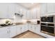 Bright kitchen with white cabinets, stainless steel appliances, and granite countertops at 14684 Cherry Blossom Way, Punta Gorda, FL 33955