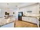 Modern kitchen features granite countertops, stainless steel appliances, and white cabinetry at 14684 Cherry Blossom Way, Punta Gorda, FL 33955