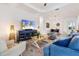 Bright and airy living room with stylish furnishings, a large TV, and seamless access to the dining area at 14684 Cherry Blossom Way, Punta Gorda, FL 33955