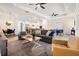 Inviting living room with an open layout, modern furnishings, and seamless access to the kitchen and dining area at 14684 Cherry Blossom Way, Punta Gorda, FL 33955