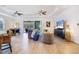 Spacious living room featuring a ceiling fan, stylish decor, and seamless access to the screened lanai and pool at 14684 Cherry Blossom Way, Punta Gorda, FL 33955