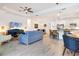 Open-concept living space with a modern kitchen, dining area, and comfortable living room with wood-look tile at 14684 Cherry Blossom Way, Punta Gorda, FL 33955