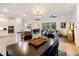 Open-concept living space featuring a stylish dining area and an inviting living room with wood-look tile floors at 14684 Cherry Blossom Way, Punta Gorda, FL 33955