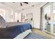 Well-lit main bedroom with access to a screened patio, soft carpet, and light neutral colors at 14684 Cherry Blossom Way, Punta Gorda, FL 33955
