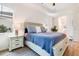 Well-lit main bedroom featuring neutral colors, tray ceilings, and wood-look tile floors at 14684 Cherry Blossom Way, Punta Gorda, FL 33955