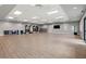 Bright yoga room with wood floors, mirrored wall and plenty of workout equipment and space for classes at 14684 Cherry Blossom Way, Punta Gorda, FL 33955