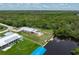 Home with waterfront access, lush landscaping, and expansive backyard at 161 Danforth Dr, Punta Gorda, FL 33980