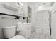 Bathroom featuring a sink, toilet, and built-in storage cabinet with black and white tile at 161 Danforth Dr, Punta Gorda, FL 33980