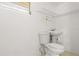 Bathroom showcasing a toilet, small sink, storage shelf, and white tile walls at 161 Danforth Dr, Punta Gorda, FL 33980