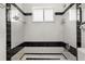 Bathroom shower space with black and white tile walls and fixtures at 161 Danforth Dr, Punta Gorda, FL 33980