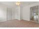 Bedroom showcasing multiple doors, tile flooring, a ceiling fan, and natural light at 161 Danforth Dr, Punta Gorda, FL 33980