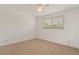 Bedroom features neutral walls, tile flooring, and a window with natural light at 161 Danforth Dr, Punta Gorda, FL 33980