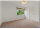 Bedroom features tile flooring, a window with views, and a door for easy access at 161 Danforth Dr, Punta Gorda, FL 33980
