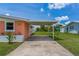 Side view of a home with a covered parking area and manicured lawn at 161 Danforth Dr, Punta Gorda, FL 33980