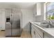Updated kitchen featuring stainless steel refrigerator and bright white cabinets at 161 Danforth Dr, Punta Gorda, FL 33980