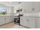 Modern kitchen with stainless steel appliances, white cabinetry, and tile backsplash at 161 Danforth Dr, Punta Gorda, FL 33980