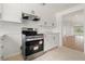 Bright kitchen with white cabinets, modern appliances, and tile flooring at 161 Danforth Dr, Punta Gorda, FL 33980