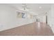 Spacious living room with neutral tile flooring, ceiling fans, and plenty of natural light at 161 Danforth Dr, Punta Gorda, FL 33980