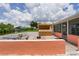 View of the waterfront patio and tiki bar from the yard of this lovely home at 161 Danforth Dr, Punta Gorda, FL 33980