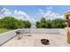Waterfront patio with outdoor table, fire pit, and tiki bar for relaxing and entertaining at 161 Danforth Dr, Punta Gorda, FL 33980