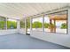 Enclosed patio with a painted floor, tongue and groove ceiling, and views of a tropical outdoor bar at 161 Danforth Dr, Punta Gorda, FL 33980
