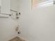 Utility room features plumbing hookups and a small window for ventilation and natural light at 161 Danforth Dr, Punta Gorda, FL 33980