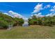 Private backyard waterfront with dock and serene views of the lush surroundings and open water at 161 Danforth Dr, Punta Gorda, FL 33980