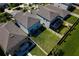 Aerial view showcasing a home with a fenced backyard, patio, and neighboring properties, offering privacy at 17032 Yellow Pine St, Wimauma, FL 33598