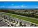 Aerial view of a residential area with homes near a greenbelt and roadway at 17032 Yellow Pine St, Wimauma, FL 33598