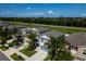 Aerial view showcases the well-maintained neighborhood with lush green trees and manicured lawns at 17032 Yellow Pine St, Wimauma, FL 33598