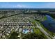 An aerial view of a Primary-planned community featuring a pool, clubhouse, tennis courts, and homes with well-manicured lawns at 17032 Yellow Pine St, Wimauma, FL 33598