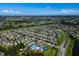 This aerial view highlights the community's layout with winding roads, beautiful landscaping, and a picturesque golf course at 17032 Yellow Pine St, Wimauma, FL 33598