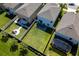 Aerial view of fenced backyard featuring a fire pit, patio, lush lawn, and mature landscaping at 17032 Yellow Pine St, Wimauma, FL 33598