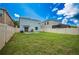 A backyard that features a well-maintained lawn, privacy fence, and a paved patio area off the back of the home at 17032 Yellow Pine St, Wimauma, FL 33598