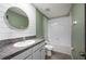 The bathroom features a white vanity with granite counters and a shower-tub combination at 17032 Yellow Pine St, Wimauma, FL 33598