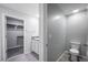 Bright bathroom featuring tiled floors, single vanity and open access to a closet with installed shelving at 17032 Yellow Pine St, Wimauma, FL 33598